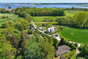 an aerial view of a farm with a house and trees at Landhaus Möhlend in Waase