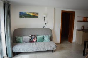 a couch with pillows on it in a room at Képes Vendégház in Tokaj