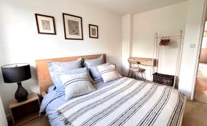a bedroom with a bed with blue and white sheets at Guest Rooms Apsley Lock in Hemel Hempstead +40 photos