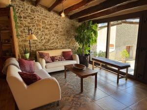 a living room with two couches and a table at Refugi de l'Albera in Vilamaniscle