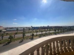 a view from a balcony of a street with palm trees at شقه مفروشه الاسكندريه برج العرب الجديده الحي الثاني in Burj al ‘Arab al Jadīdah