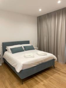 a bedroom with a large bed with white sheets at Casa Quetta in Bari +18 photos