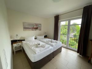 Postel nebo postele na pokoji v ubytování Usedom Bike Hotel & Suites