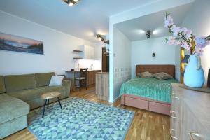 a living room with a bed and a couch at Kristalli 8-2 apartment in Tartu