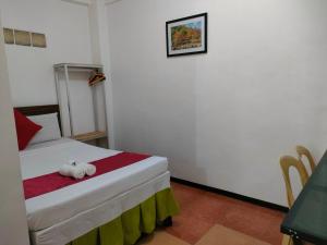 Voodi või voodid majutusasutuse Axis Pension Hotel toas