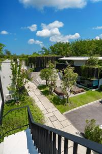 a view of the garden from the balcony of a house at Modern 3 Bdr Villa Tree O'Clock Bangtao With a Pool in Ban Pak Lak