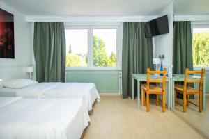 Postel nebo postele na pokoji v ubytování Thermae Grimbergen Hotel