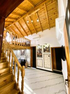 a staircase in a house with wooden ceilings at Republika Central Hotel & Resort in Abbottabad
