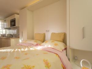 a bedroom with a bed with two pillows at Charmant studio rénové avec terrasse, climatisation et WiFi gratuit - FR-1-196-166 in Menton