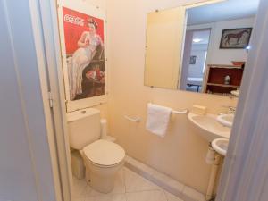 a bathroom with a toilet and a sink and a mirror at Grand 2P climatisé, terrasse, parking, centre Menton, commerces & plages à pied - FR-1-196-189 in Menton +7 photos