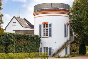 a house with a lighthouse on the side of it at Urlaub im historischen Türmchen am Westwall in Xanten