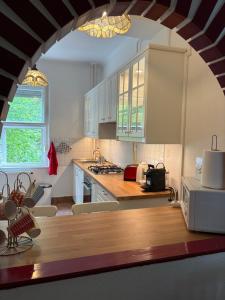 a kitchen with white cabinets and a counter top at Rubinstein Relax Apartman in Budapest
