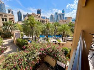 a view of a resort with palm trees and flowers at 1001 Nights - Luxury 1-BR apartment near Burj in Dubai