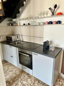 a kitchen with a sink and a counter at Casa Fiocchetto - Giardini Reali in Turin +9 photos