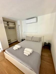 a bedroom with a bed with two towels on it at Casa Fiocchetto - Giardini Reali in Turin