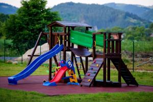 a playground with a slide and a slideintend at Pensiunea Lavanda in Bratca