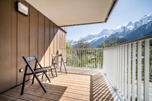 two chairs on a deck with mountains in the background at Apartment Houchma Les Houches - by EMERALD STAY in Les Houches