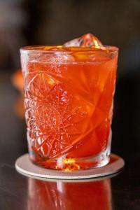 a drink sitting on a table with a drink at AH Premium Baia dei Faraglioni in Mattinata