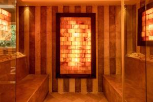 a bathroom with a shower and a fireplace at AH Premium Baia dei Faraglioni in Mattinata