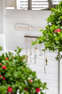 a string of bells hanging on a white wall at AH Premium Baia dei Faraglioni in Mattinata