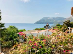 a view of the ocean from a garden with flowers at Jerà Suite Vista Mare 19 in Lipari