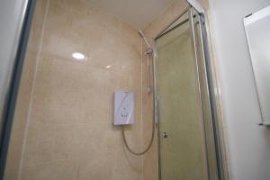 a bathroom with a shower with a glass door at Gosford Park Studio 4 - Coventry in Coventry
