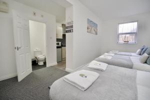 a bedroom with two beds with towels on them at Gosford Park Studio 4 - Coventry in Coventry
