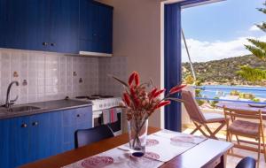 a kitchen with a table with a vase of flowers on it at Porto Buffalo Studios in Boufalo