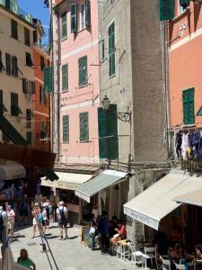 a group of people walking around a street with buildings at Margot in Vernazza +15 photos