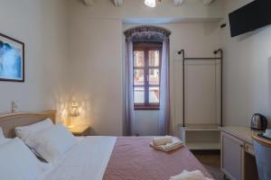 Postel nebo postele na pokoji v ubytování Authentic Suites in Fiscardo (Archontiko)