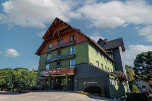a large building with a brown roof at Hotel Laghetto Viale in Gramado