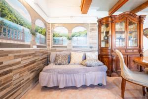 a room with a bed and a table and chairs at Villa Mimosa in Porto Pino