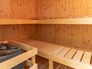 a sauna with wooden walls and wooden shelves at Holiday Home Blu Hus in Freest