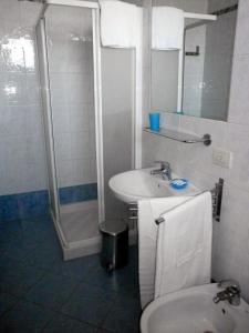 a bathroom with a sink and a shower and a toilet at Residence Carioca in Rimini