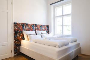 Postel nebo postele na pokoji v ubytování GH Luxury Apartments Graz, Gösser Haus