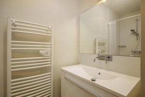 a white bathroom with a sink and a mirror at Wooden Villa 4 in Veyrier-du-Lac +41 photos