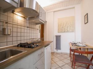 a kitchen with a sink and a table with chairs at Waterfall San Lorenzo in Isola del Liri