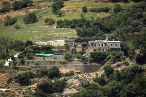 an old house on a hill in the mountains at Anastasia Luxury Villas in Gavrio