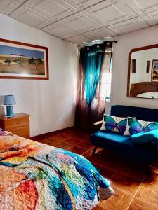 a bedroom with a bed and a couch in it at Casa da Bia in Nisa