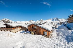 a house on top of a snow covered mountain at Chalet RIVA ski in-out Plagne Village in La Plagne Tarentaise