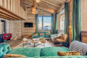 a living room with a couch and a table at Chalet RIVA ski in-out Plagne Village in La Plagne Tarentaise
