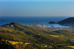 a view of a hill with the ocean in the background at Anastasia Luxury Villas in Gavrio