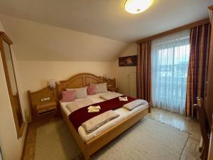 a bedroom with a bed and a large window at Weingut Giessauf-Nell in Klöch