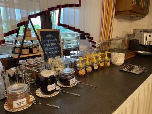 a counter with many jars of food on a counter top at Weingut Giessauf-Nell in Klöch +15 photos