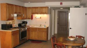 a kitchen with wooden cabinets and a table and a sink at Beaver Creek Inn in Lake Montezuma