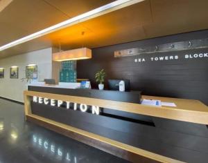 a restaurant with a reception desk in a building at APRT with marvelous sea view in Batumi