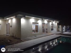 a house with a swimming pool at night at Villa los abuelos in Cataltzul