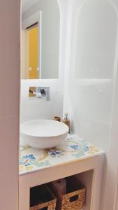a bathroom with a sink and a mirror on a counter at Talamo Room Boutique in Naples