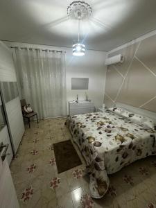 a bedroom with a large bed and a table at Casa vacanze I mori in Bagheria