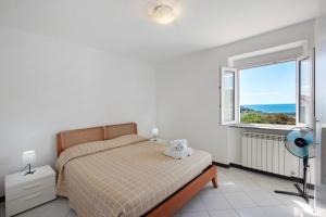 a bedroom with a bed and a large window at Villa Zafferano Suites - Origano in Celle Ligure